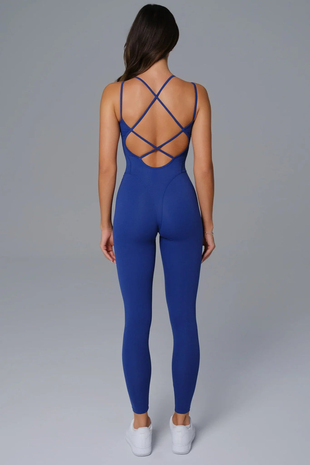 Midnight Blue jumpsuit with criss-cross back design on a plain background