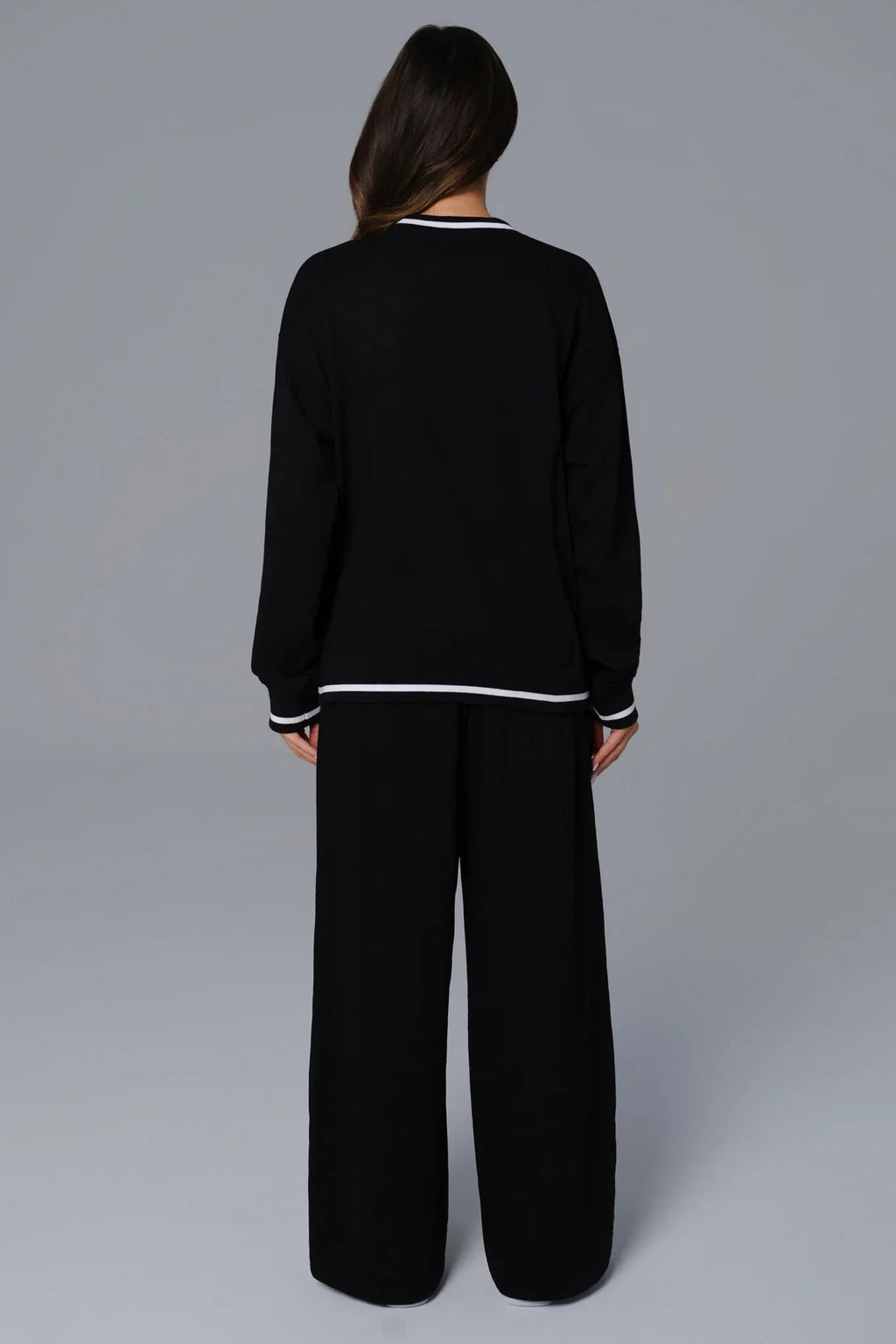 Person wearing a black casual athleisure matching set