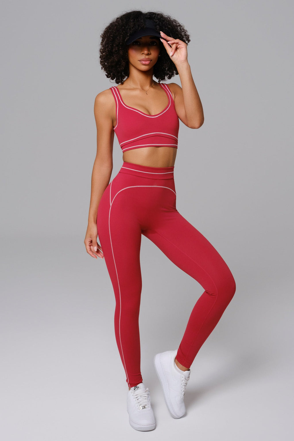 Woman wearing cherry red athleisure workout set