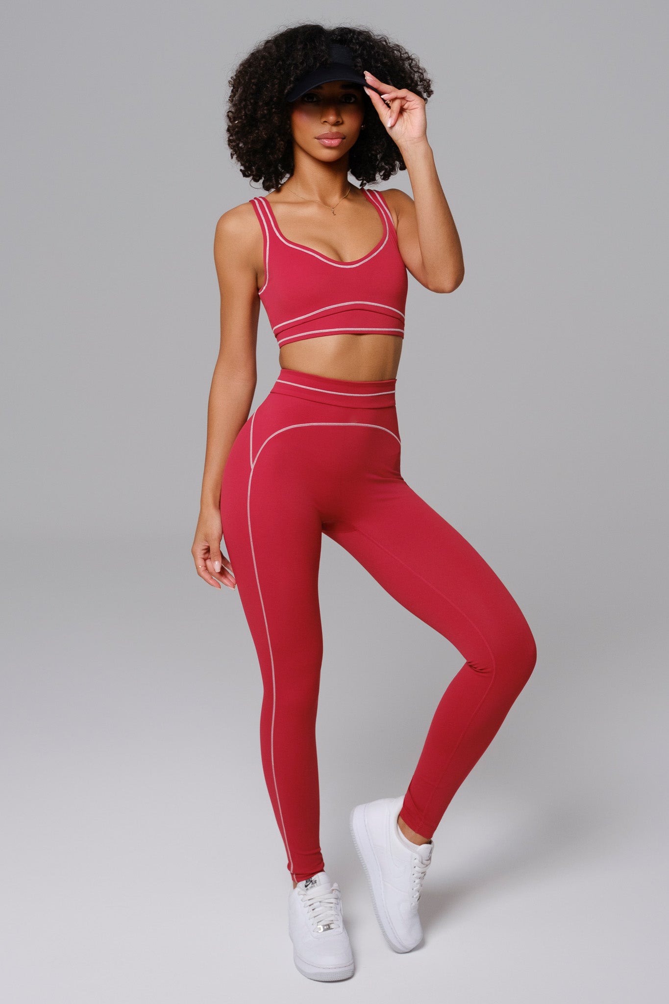 Woman wearing cherry red athleisure workout set