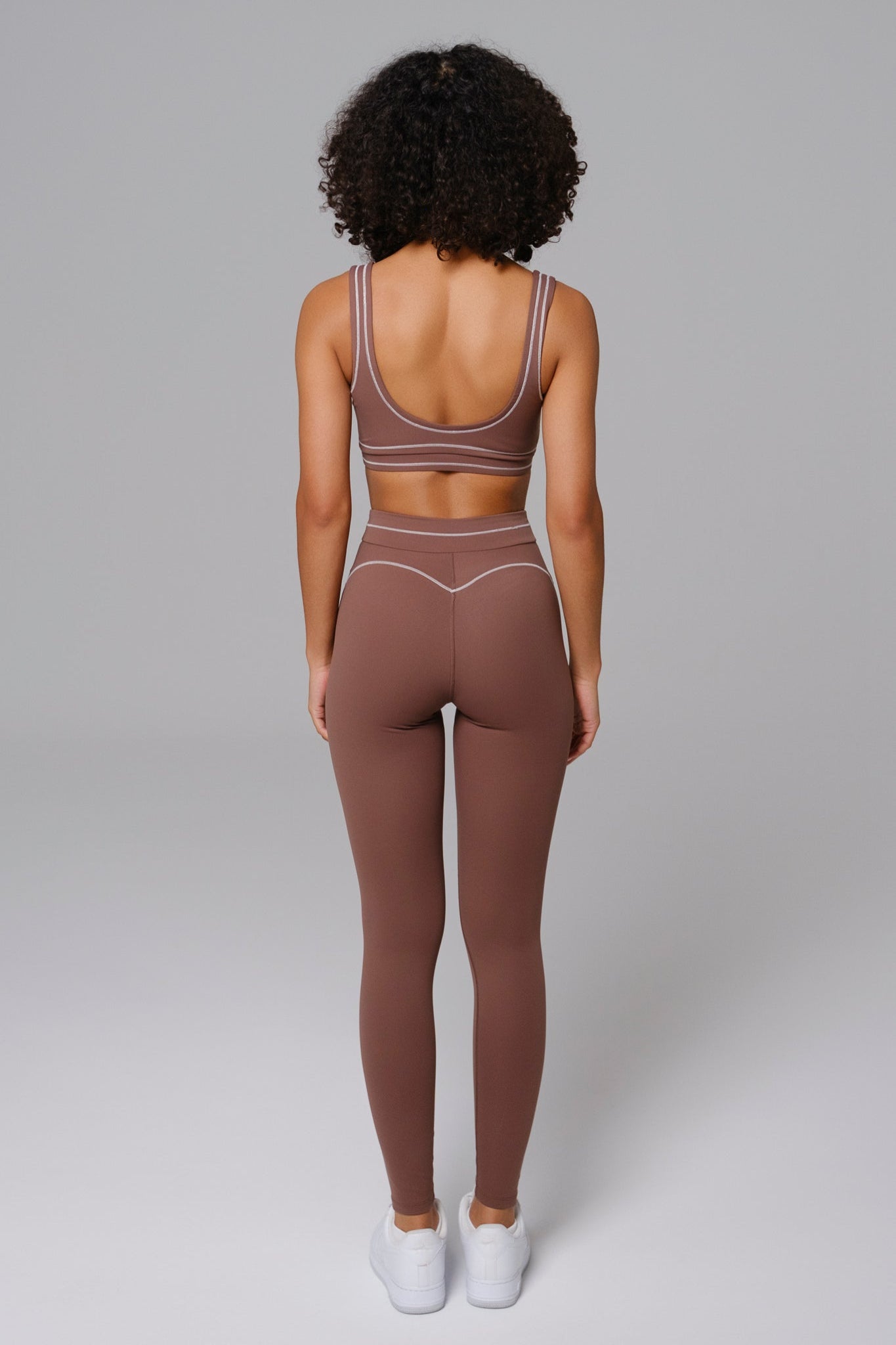 Woman wearing a Mocha workout sports bra and leggings set