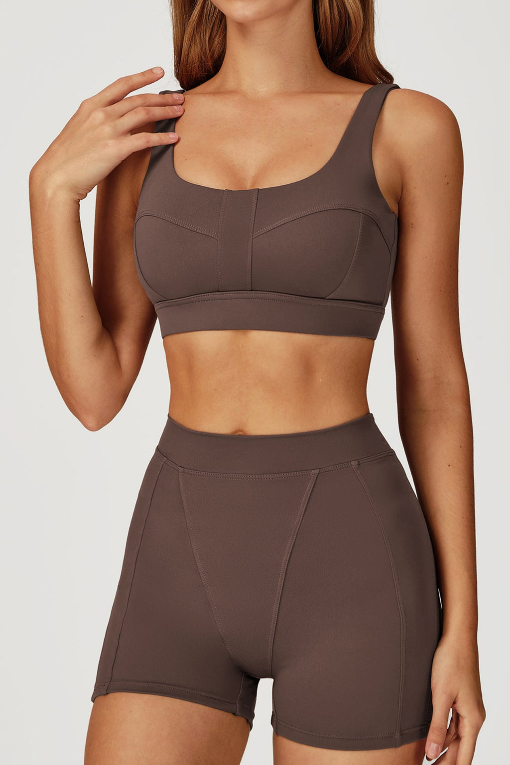 Person wearing a Burnt Umber sports bra and shorts set 