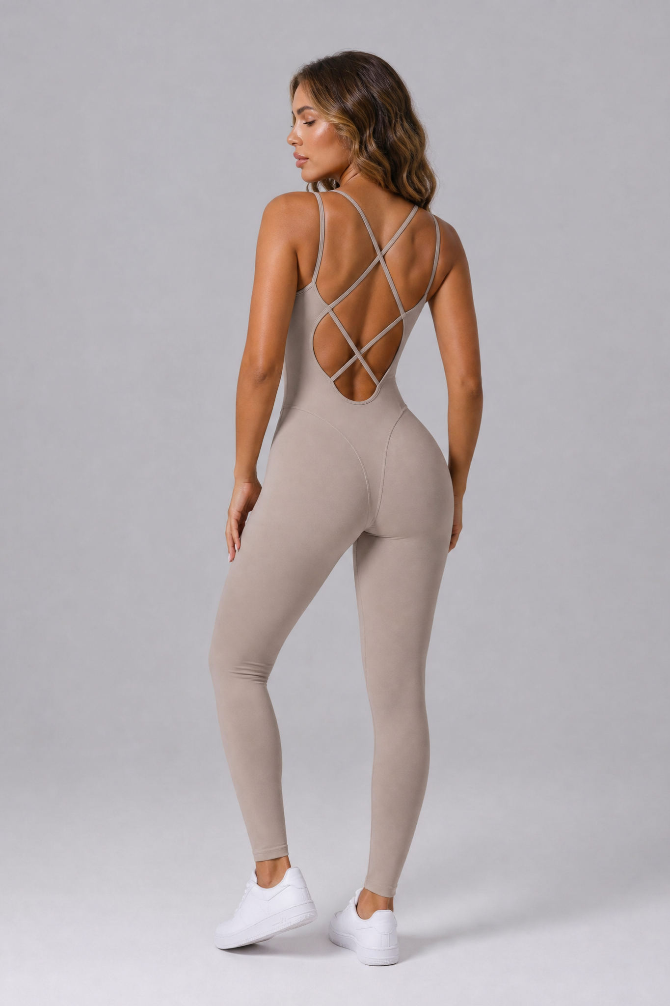 Woman wearing the Sculpt jumpsuit in Ash Taupe