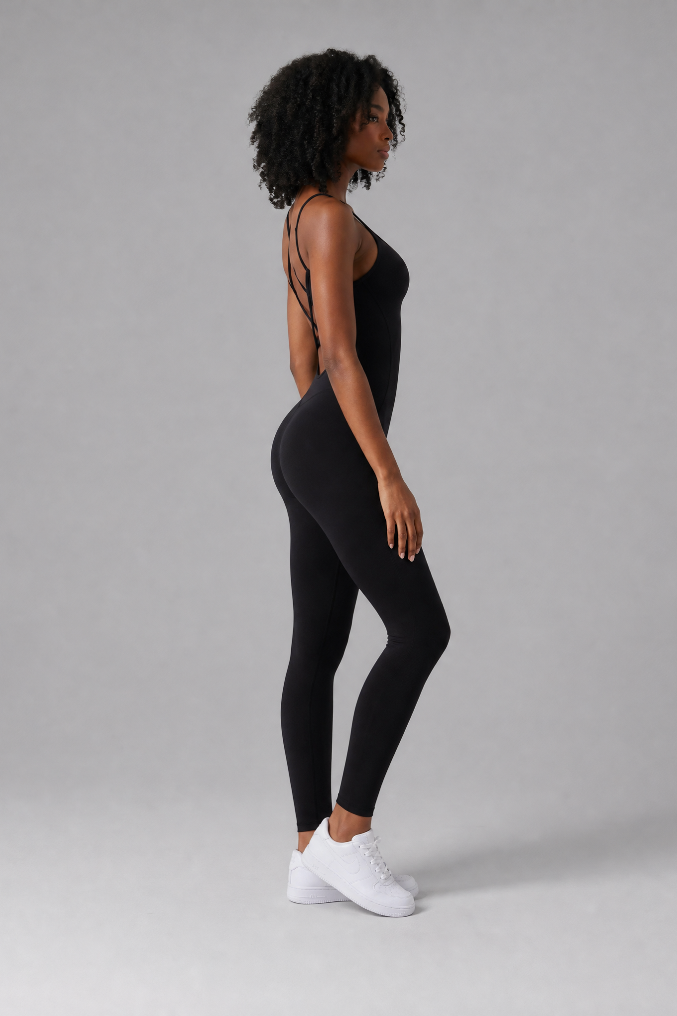 Woman wearing the Sculpt jumpsuit in Black