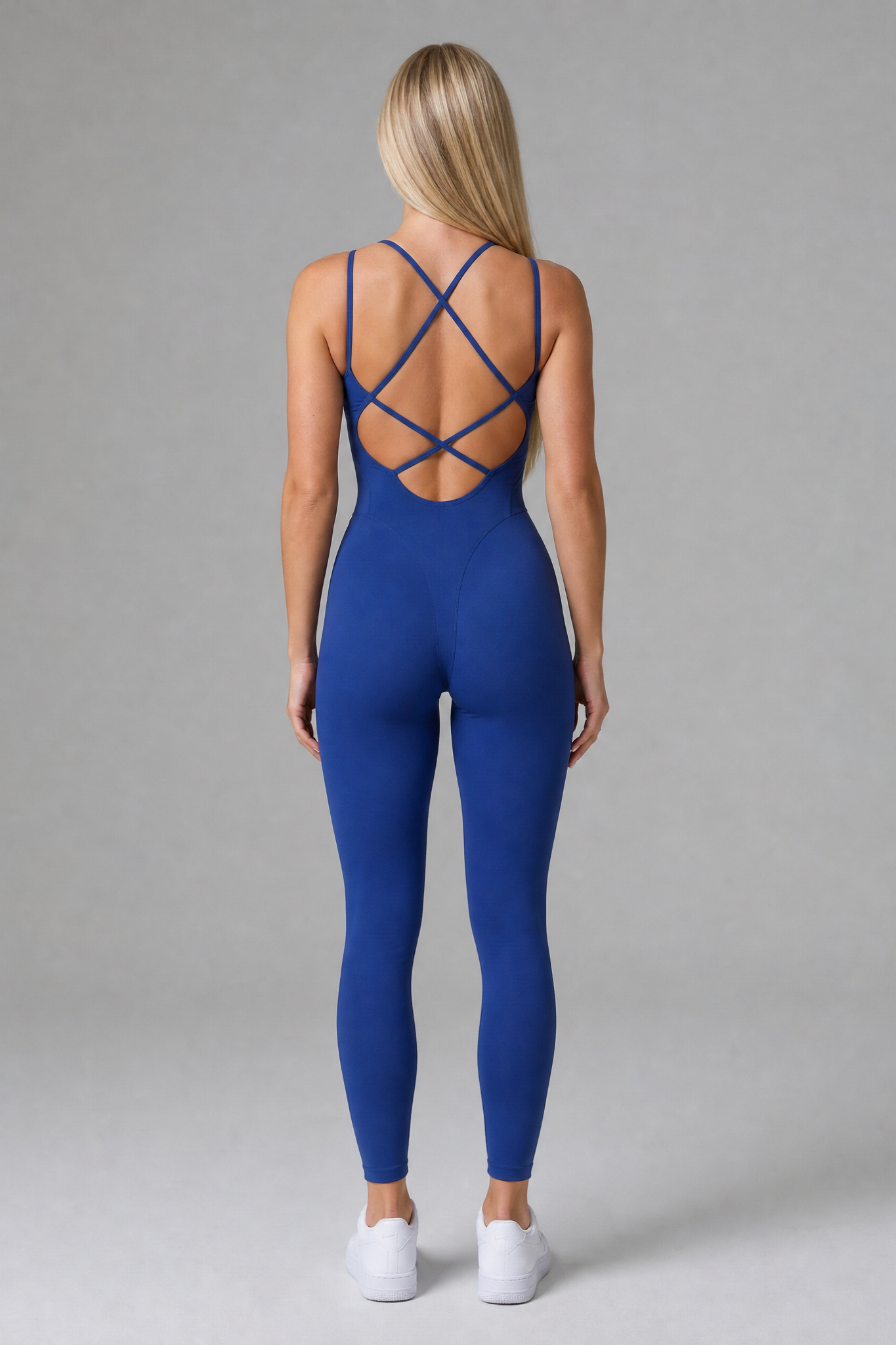 Woman wearing the Sculpt jumpsuit in Midnight Blue