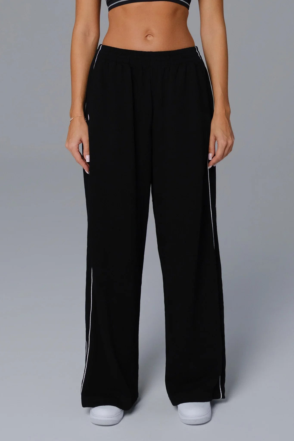 Woman wearing black wide-leg sweatpants 