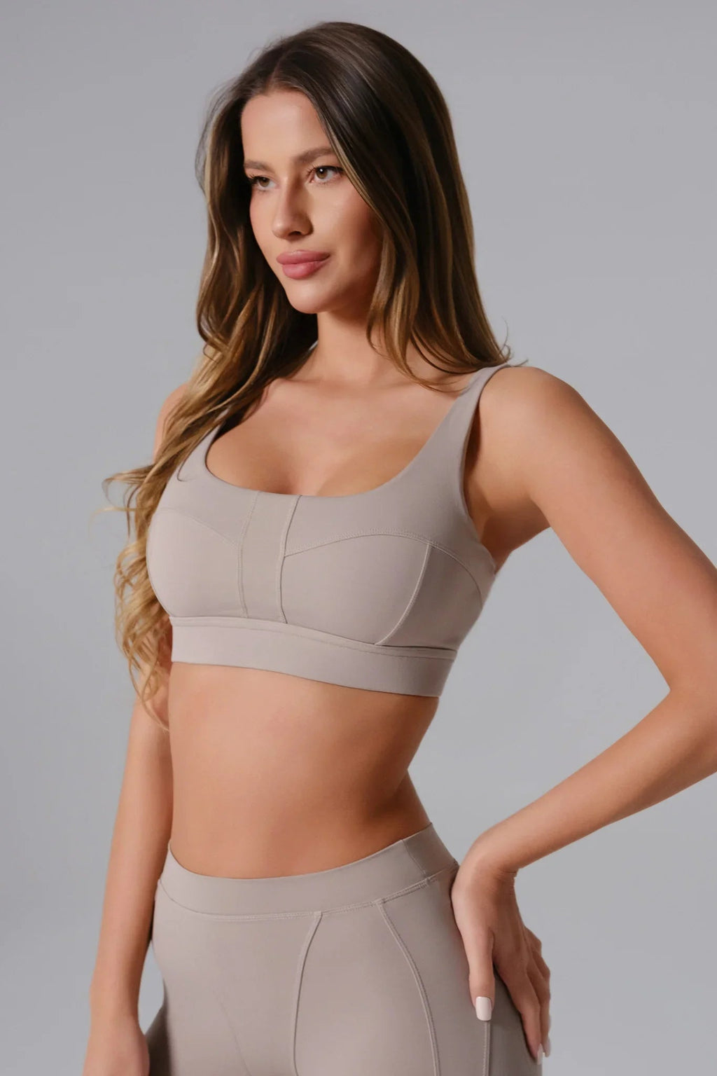 Woman wearing a Ash Taupe sports bra